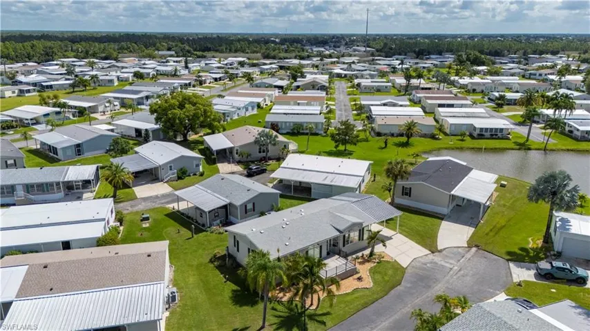 Aerial view of residential area featuring a nearby body of water