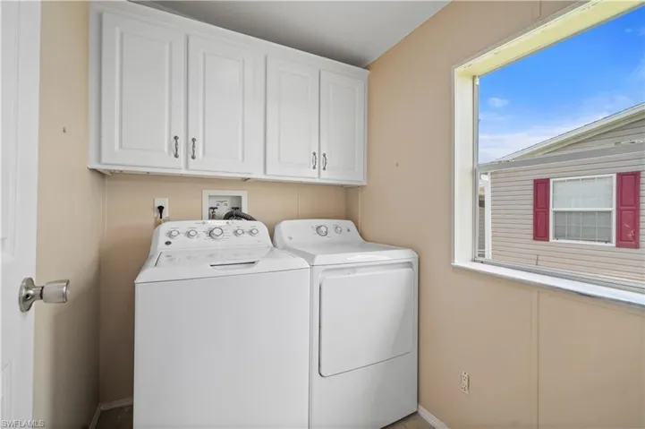 Laundry area featuring cabinet space and washer and dryer