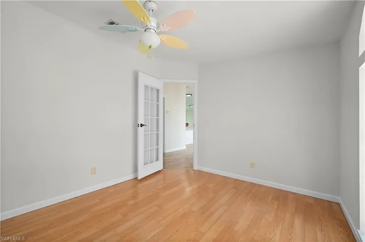 Spare room featuring light wood-style floors and ceiling fan