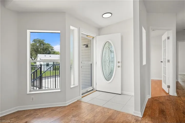 Foyer featuring wood finished floors and baseboards