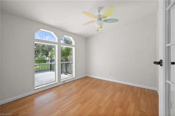 Empty room with light wood finished floors and ceiling fan