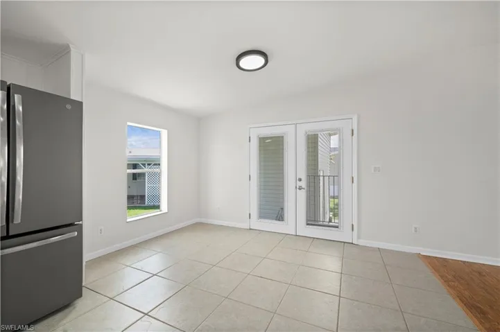 Spare room with french doors and light tile patterned floors