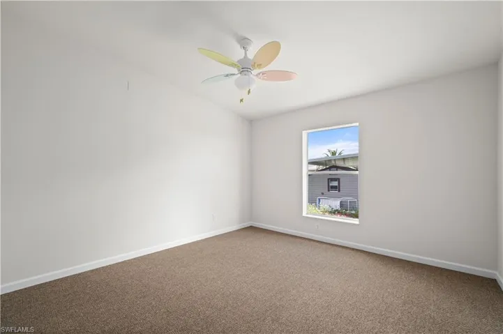 Spare room with carpet flooring and a ceiling fan