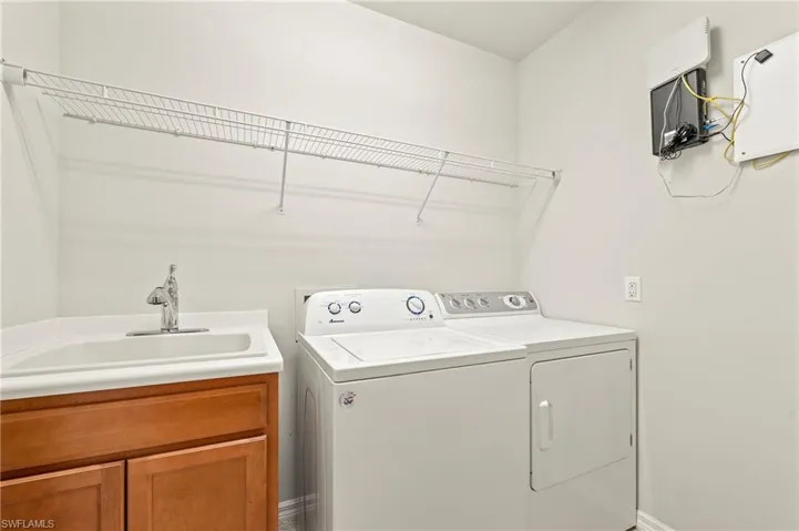 15021 Auk Way Bonita Springs FL 34135 - Upstairs laundry room with utility sink.