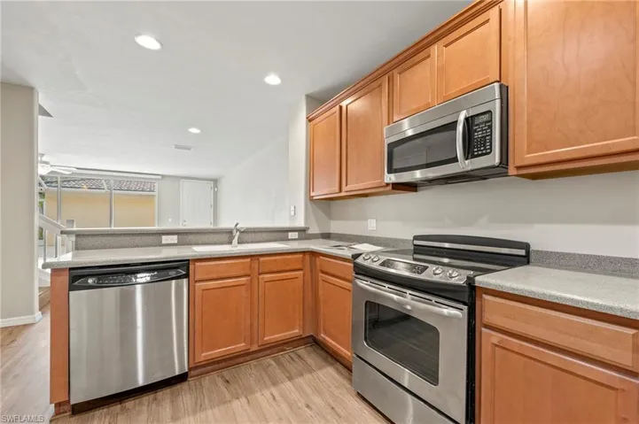 15021 Auk Way Bonita Springs FL 34135 - Kitchen is open to dining and living areas.