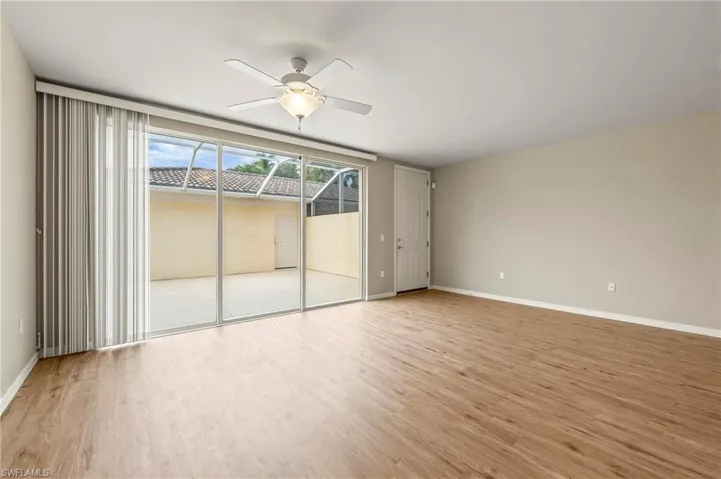 15021 Auk Way Bonita Springs FL 34135 - Living area with triple slider opens to screened courtyard patio