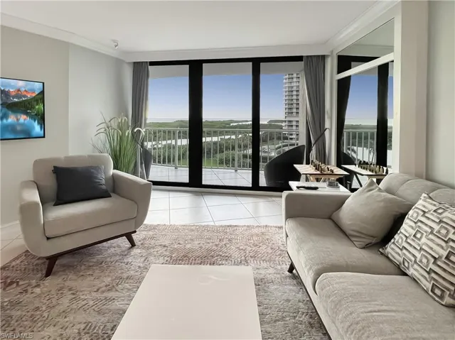 Living room featuring floor to ceiling windows, plenty of natural light, tile patterned floors, and ornamental molding