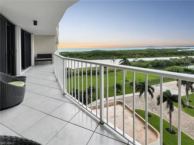 Balcony at dusk featuring a water view