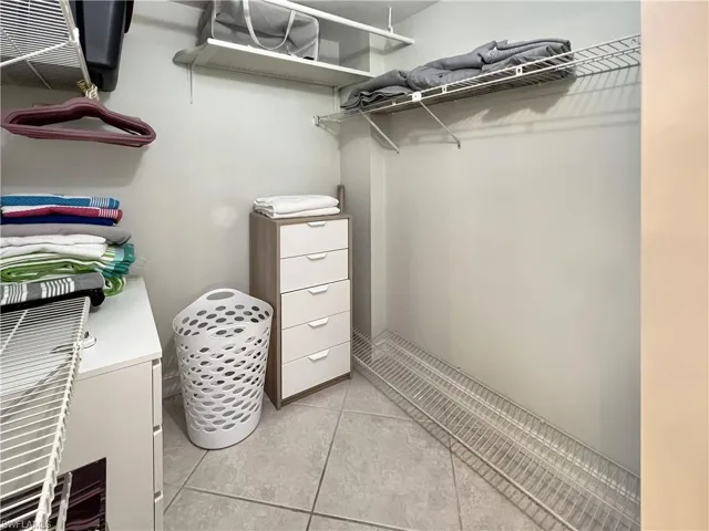 Spacious closet with light tile patterned flooring
