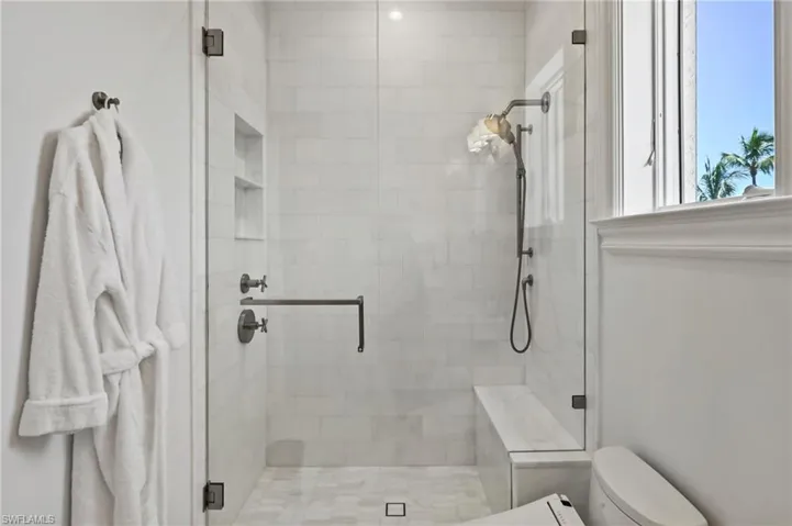 Full bath with a stall shower and toilet