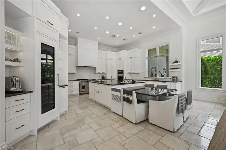Kitchen with open shelves, crown molding, white cabinets, recessed lighting, and backsplash
