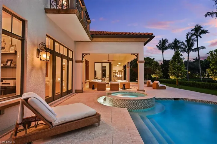 View of pool with a patio area, a pool with connected hot tub, an outdoor living space, and french doors