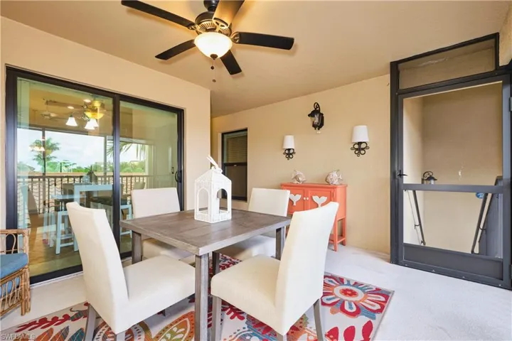 Carpeted dining space with a ceiling fan