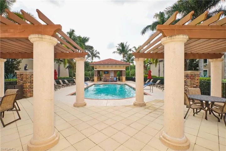 Community pool featuring a pergola and a patio area