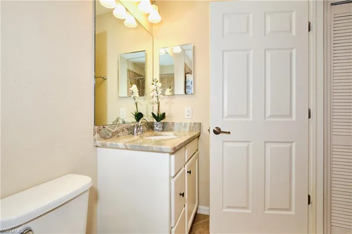 Bathroom with a closet and vanity