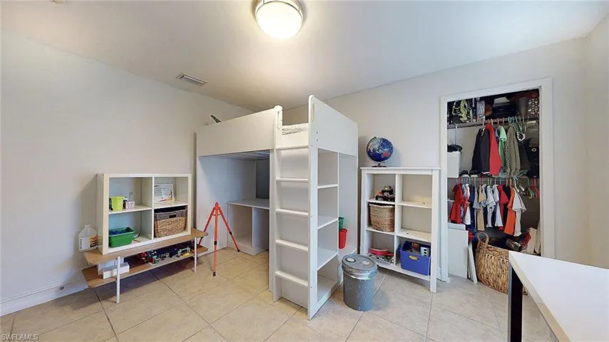 Bedroom with light tile patterned floors and baseboards