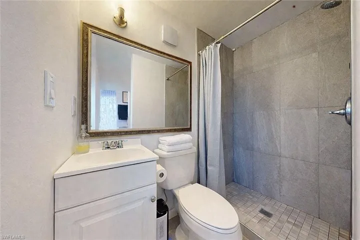 Bathroom with a shower stall and vanity