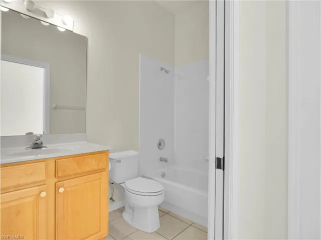 Full bathroom featuring vanity, tile flooring, and  tub/shower combination