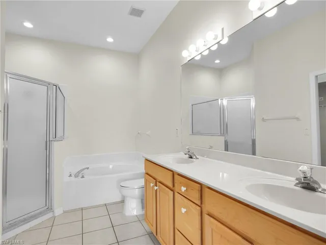 Bathroom with a shower stall, soaking tub and double vanity with lots of storage.