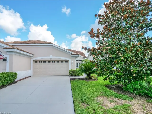 View of front of home with a garage and driveway.