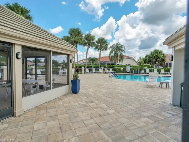 Community pool with a large patio area and community room