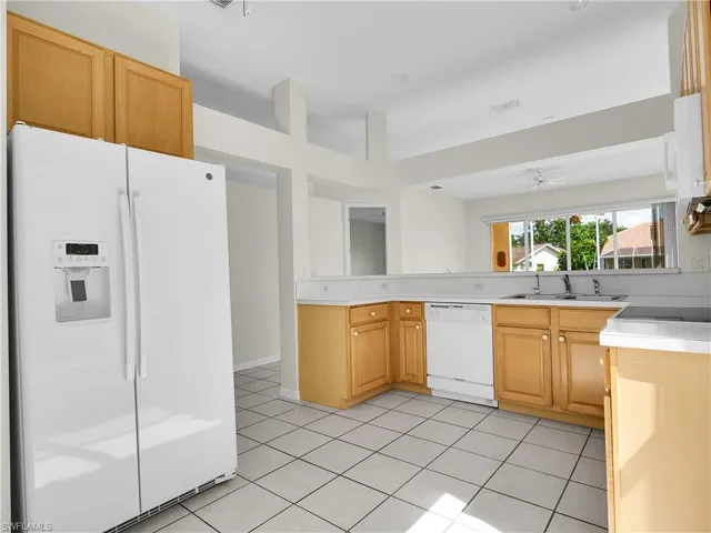 Eat-in Kitchen featuring white appliances, light countertops.