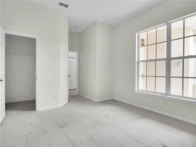 Second bedroom with a spacious walk-in closet. Large window allow for a lot of natural light.