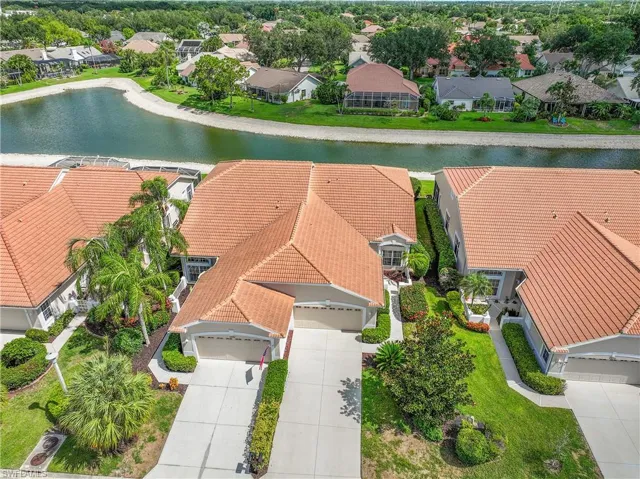 Aerial view of the home which backs up to the lake behind it.