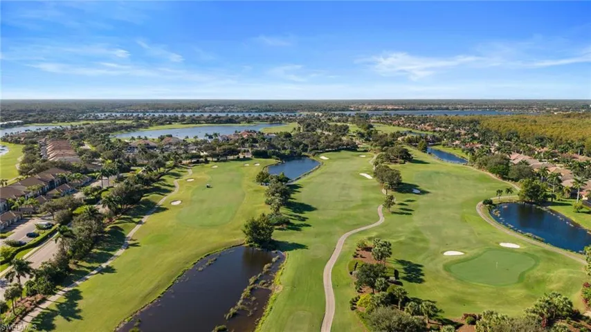 Aerial view of property's location with a nearby body of water, a local golf course, and nearby suburban area