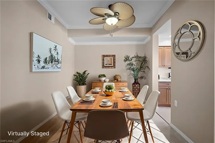 Dining space with crown molding and ceiling fan - VIRTUALLY STAGED