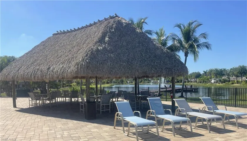 View of community with a patio area, a gazebo, a water view, and outdoor dining area
