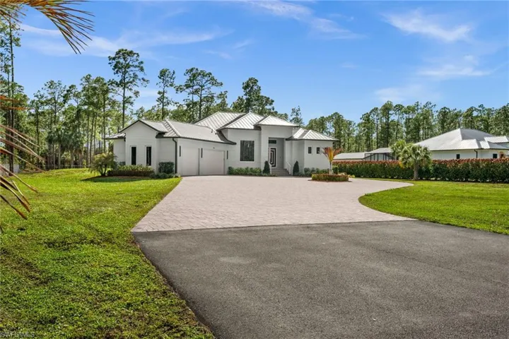 Long pavered driveway with manicured grounds