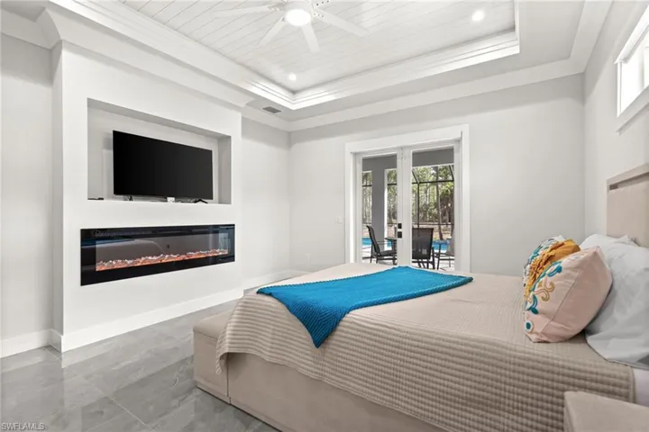 Primary bedroom overlooking pool and spa