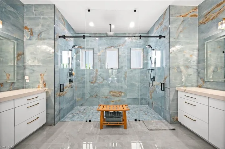 Spa like primary bathroom with his and hers vanities