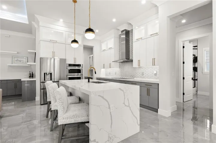 Chef's kitchen with long bar, upgraded appliances and room for everyone.
