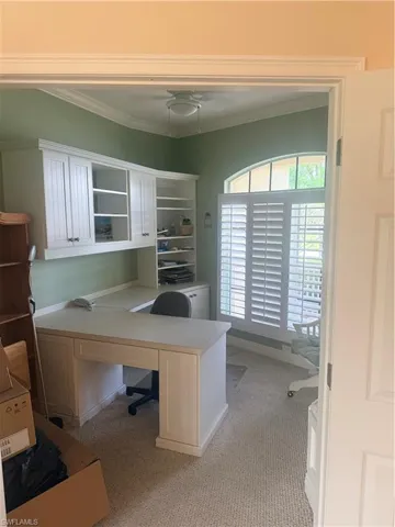 This room features built-in white cabinetry and a matching desk, providing extensive storage and workspace