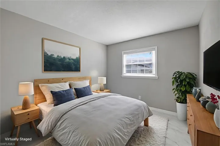 Virtually staged Bedroom with marble look tile flooring