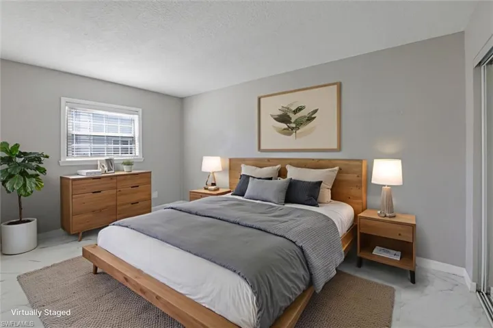Virtually staged Bedroom with light marble finish floors