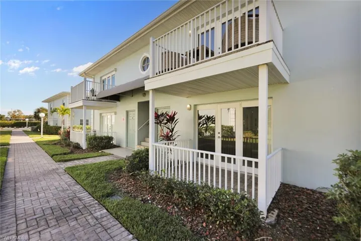View of exterior entry featuring stucco siding and french doors