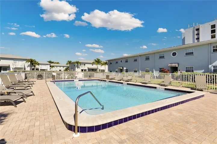 Community pool with a patio