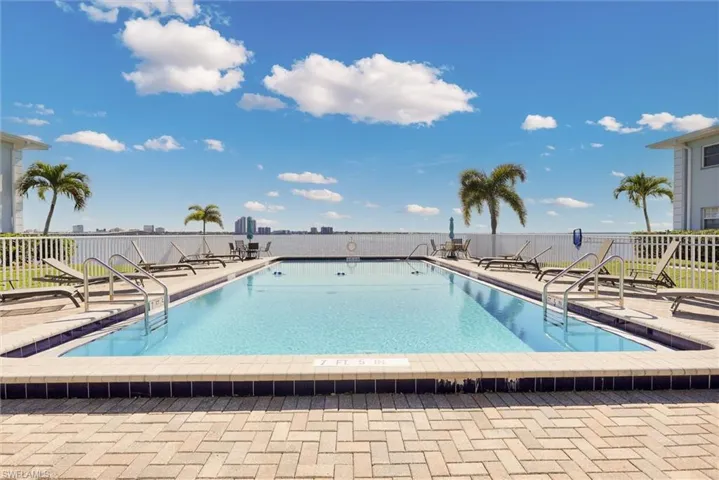 Community pool featuring a patio
