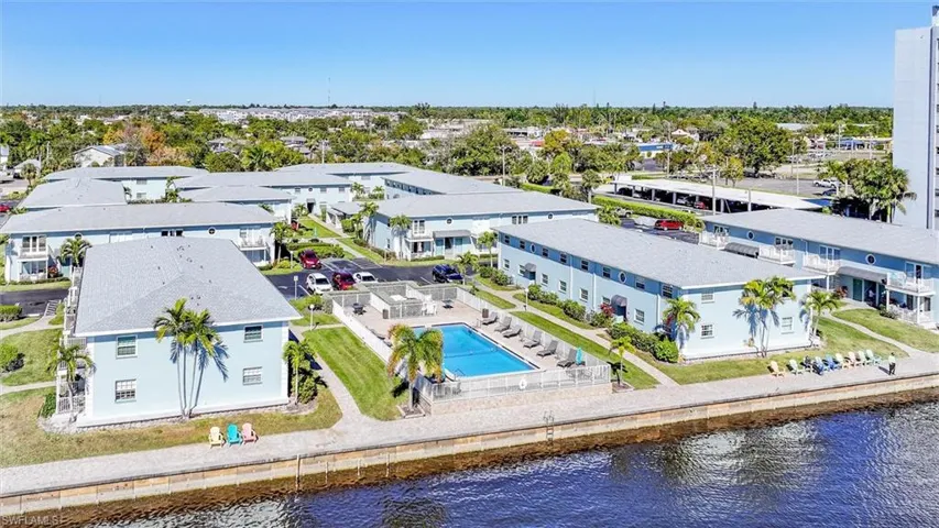 Drone / aerial view of a pool and a nearby body of water