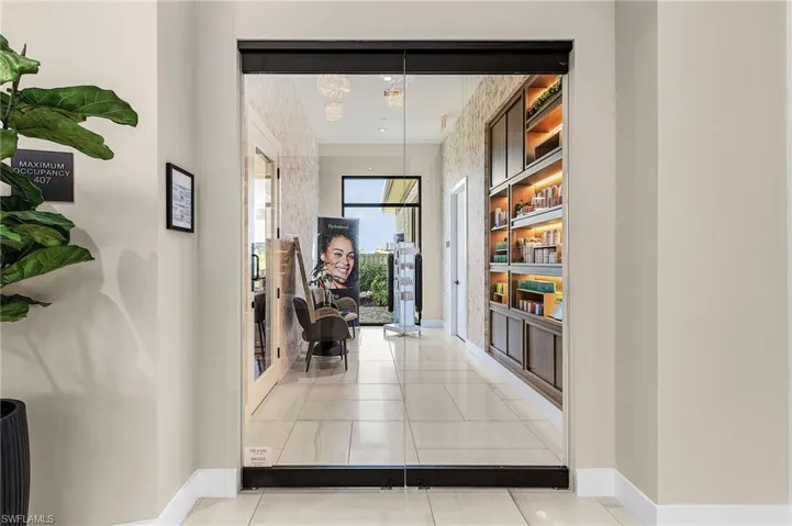 Corridor featuring baseboards and tile patterned flooring