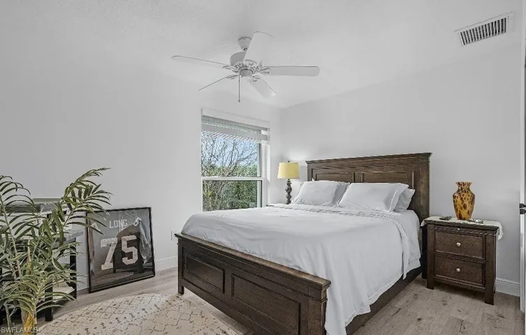 Bedroom with light wood-style flooring and a ceiling fan