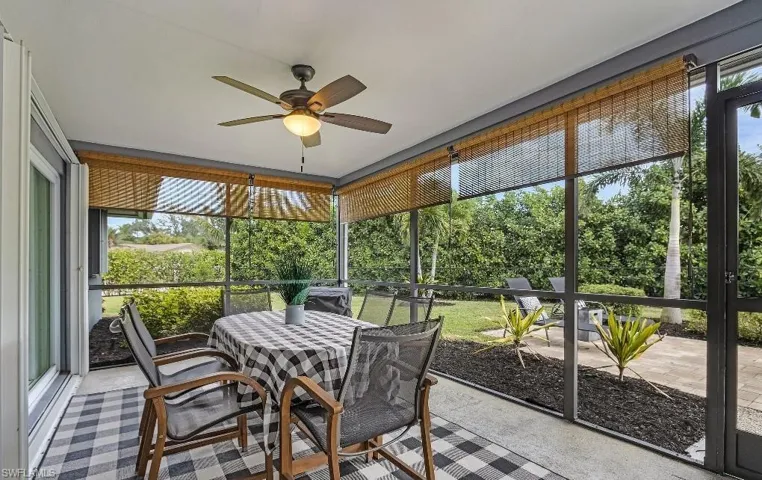 Sunroom / solarium with outdoor dining space and ceiling fan