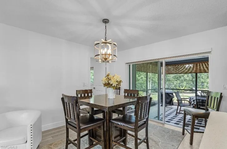 Dining room featuring light wood-style flooring and a chandelier