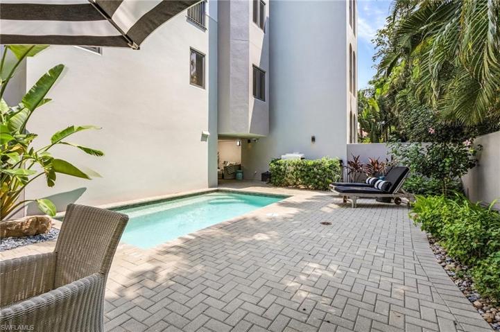 Pool leads to covered outdoor living.