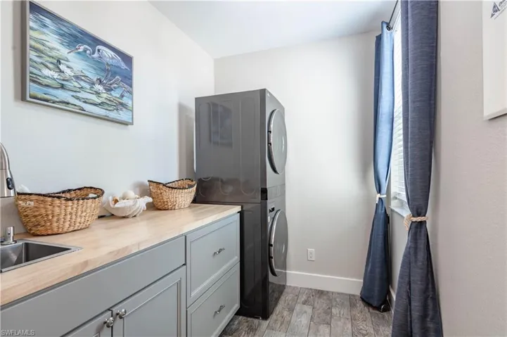 Laundry area with cabinet space, stacked washing machine and dryer