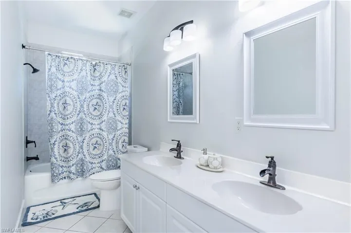 Full bathroom with tile patterned flooring