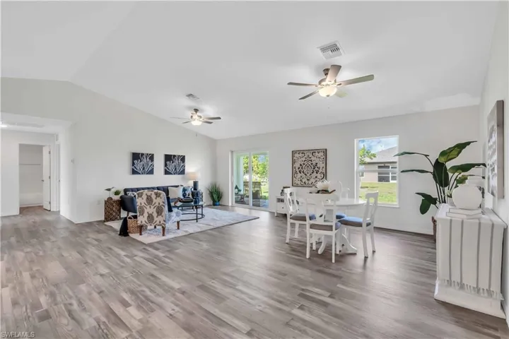 Dining room featuring plenty of natural light, visible vents, wood finished floors, and ceiling fan